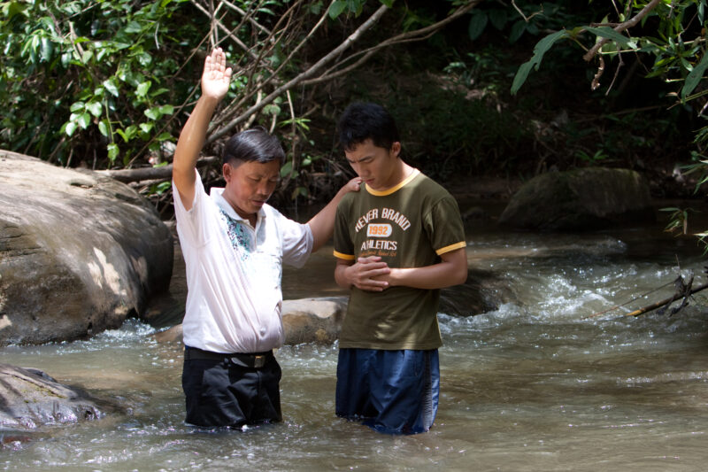 Christian Baptism in Laos — Young person becomes an Adventist Christian in the country of Laos, and is baptized in a mountian stream. — Laos, Southeast Asia,...