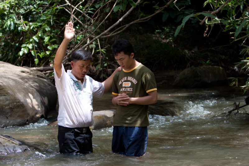 Christian Baptism in Laos — Young person becomes an Adventist Christian in the country of Laos, and is baptized in a mountian stream. — Laos, Southeast Asia,...