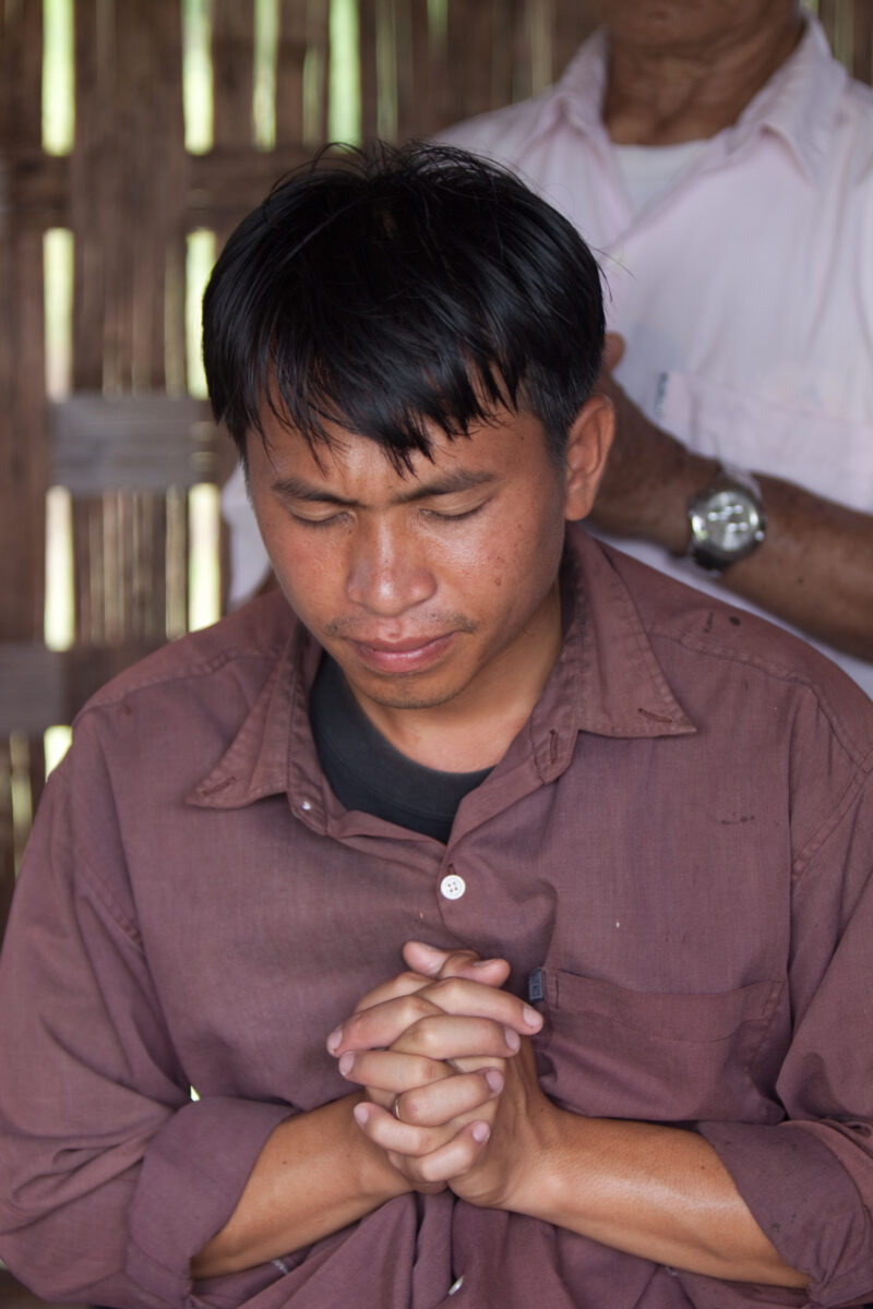 Prayer in Laos — Ethnic Minority people pray at a house church in Laos — Laos, Southeast Asia, Bible Study, Christian, Christianity