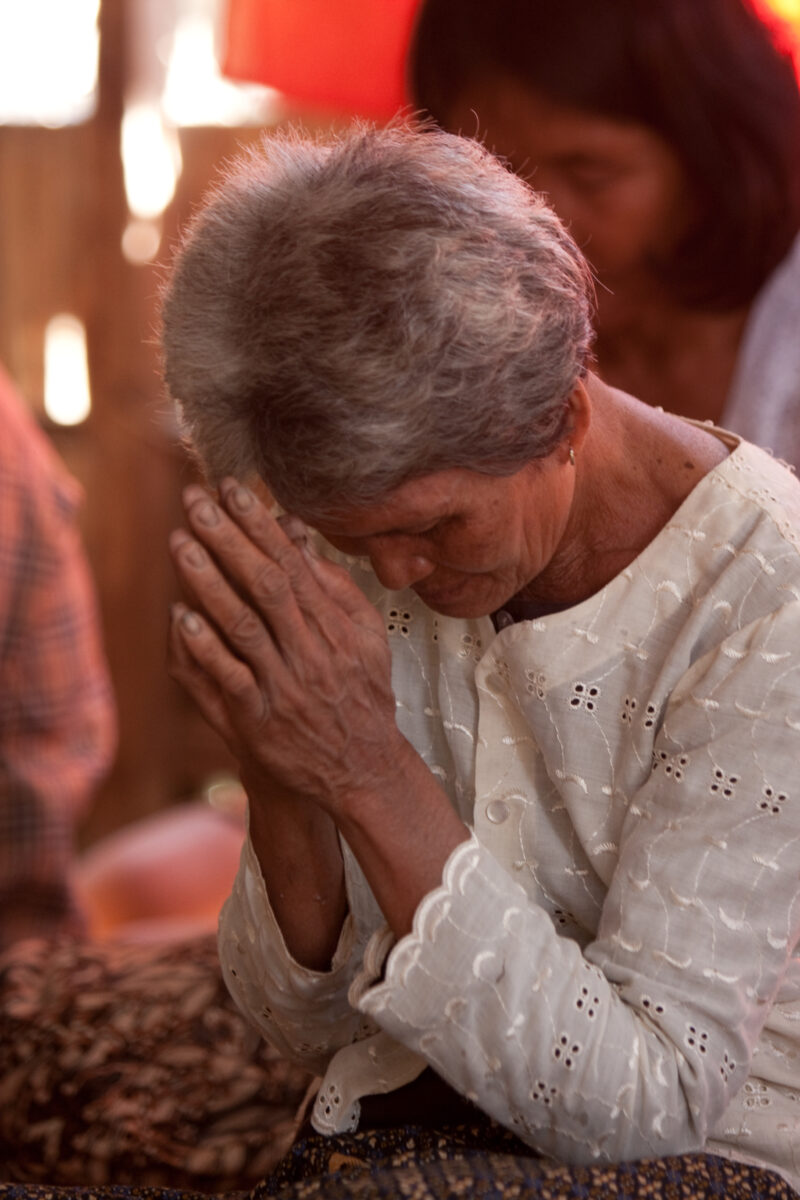 Praying in Cambodia — Seventh-day Adventist Christians in the Buddhist country of Cambodia, worship God in prayer at their simple bamboo church. — Cambodia, ...