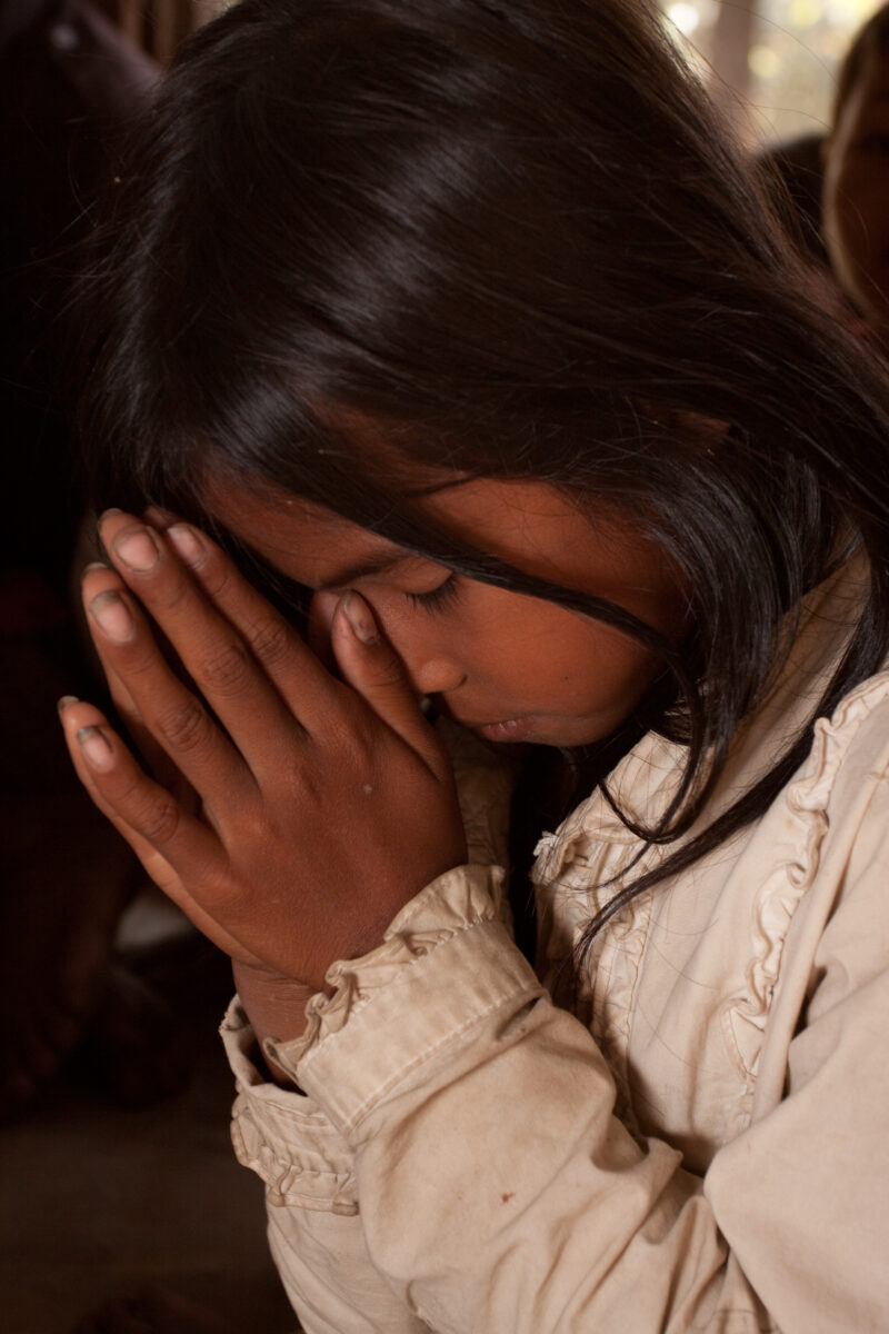 Praying in Cambodia — Seventh-day Adventist Christians in the Buddhist country of Cambodia, worship God in prayer at their simple bamboo church. — Cambodia, ...