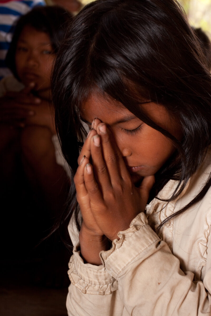 Praying in Cambodia — Seventh-day Adventist Christians in the Buddhist country of Cambodia, worship God in prayer at their simple bamboo church. — Cambodia, ...