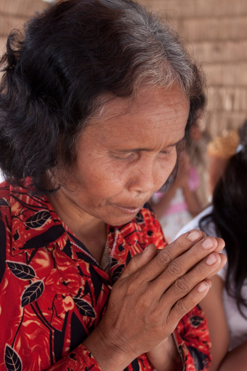 Praying in Cambodia — Seventh-day Adventist Christians in the Buddhist country of Cambodia, worship God in prayer at their simple bamboo church. — Cambodia, ...