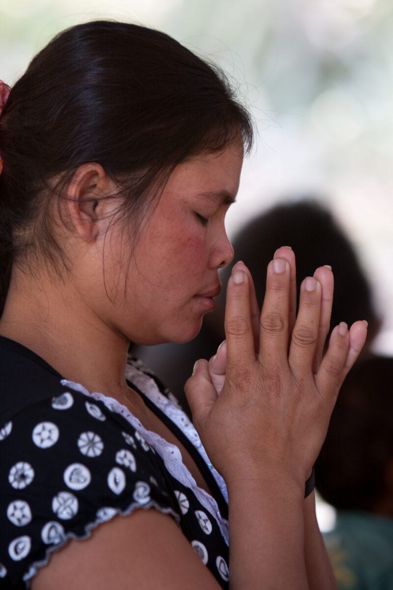 Praying in Cambodia — Seventh-day Adventist Christians in the Buddhist country of Cambodia, worship God in prayer at their simple bamboo church. — Cambodia, ...
