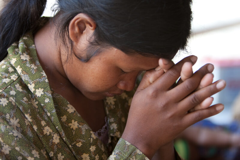 Praying in Cambodia — Seventh-day Adventist Christians in the Buddhist country of Cambodia, worship God in prayer at their simple bamboo church. — Cambodia, ...