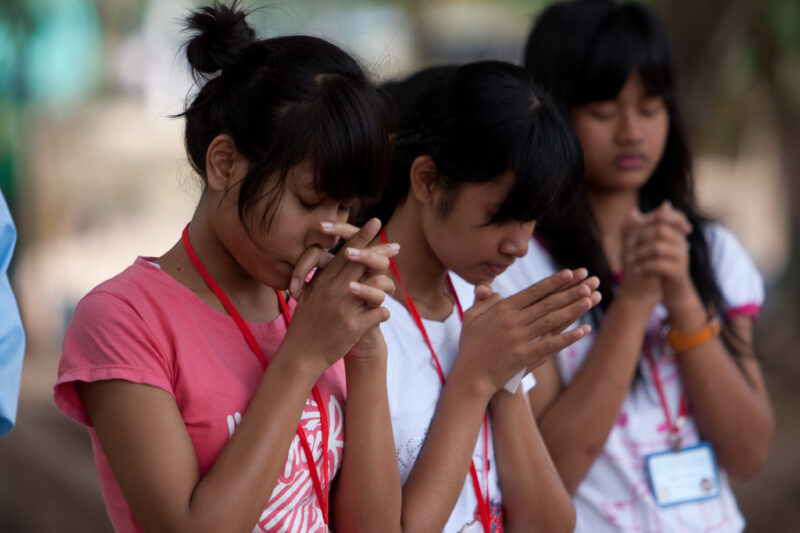 Praying in Cambodia — Seventh-day Adventist Christians in the Buddhist country of Cambodia, worship God in prayer at their simple bamboo church. — Cambodia, ...