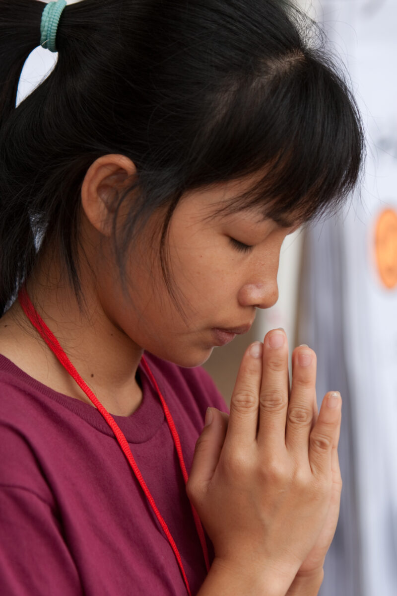Praying in Cambodia — Seventh-day Adventist Christians in the Buddhist country of Cambodia, worship God in prayer at their simple bamboo church. — Cambodia, ...