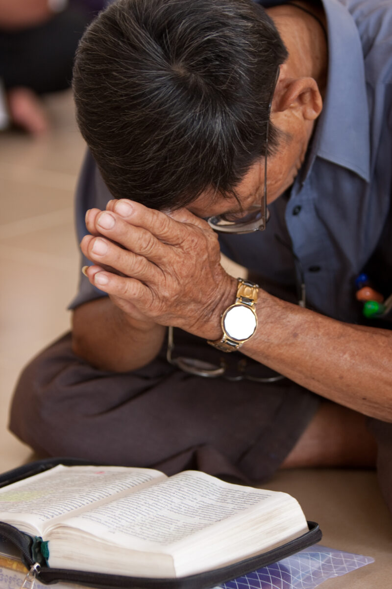 Praying in Cambodia — Seventh-day Adventist Christians in the Buddhist country of Cambodia, worship God in prayer at their simple bamboo church. — Cambodia, ...