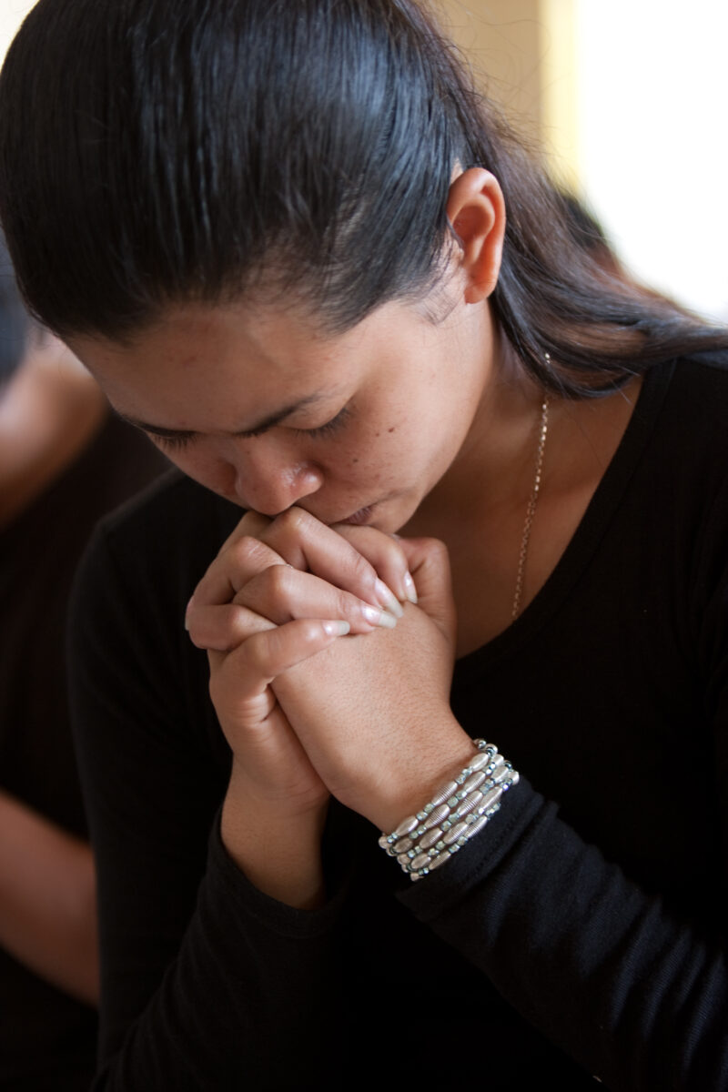 Praying in Cambodia — Seventh-day Adventist Christians in the Buddhist country of Cambodia, worship God in prayer at their simple bamboo church. — Cambodia, ...