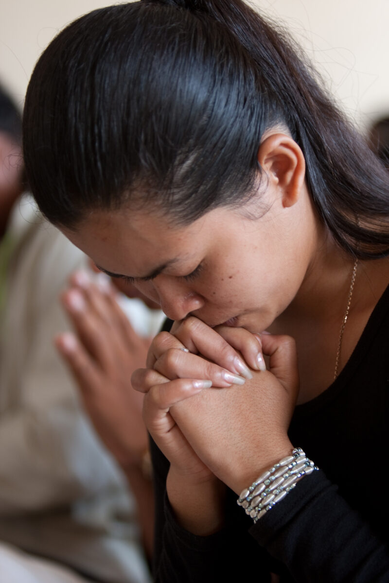 Praying in Cambodia — Seventh-day Adventist Christians in the Buddhist country of Cambodia, worship God in prayer at their simple bamboo church. — Cambodia, ...