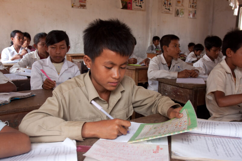 Boy in School in Cambodia — Students in a rural school in Cambodia, thanks to the Reflect group run by ADRA, that taught their parents the importance of a go...
