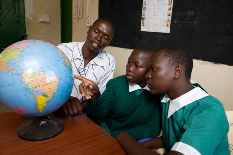 Teacher with Students and Globe — Students in the Nyburi center for disabled children learn geography at their school. — ADRA, AID, Africa, Assistance, Devel...