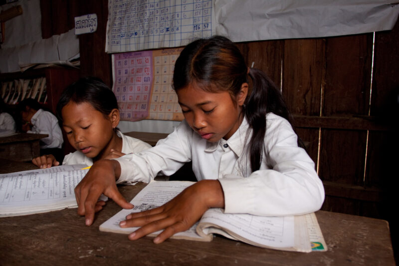 Students At Desk — Young students, now attending school in Rural Cambodia, thanks to an ADRA "reflect" program that has taught parents the value of education...