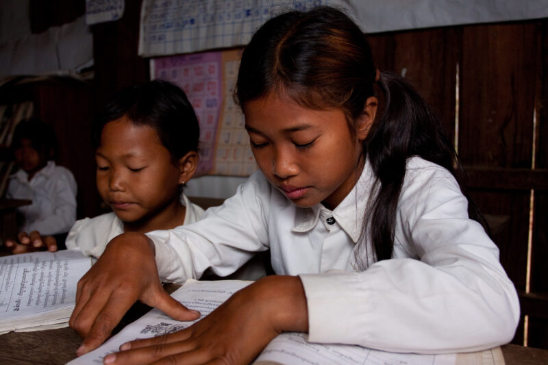 Students At Desk — Young students, now attending school in Rural Cambodia, thanks to an ADRA "reflect" program that has taught parents the value of education...