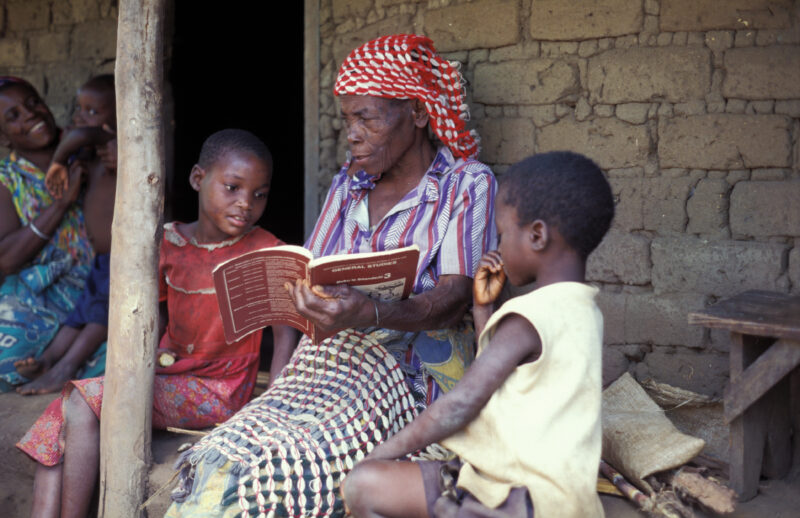 Homework in Malawi — Grandmother helps her Granddaughter with lesson — Malawi, grandmother, girl, children, lesson