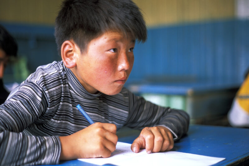 Boy in School in Mongolia — Children of nomadic herders in Mongolia make up for education that they have missed, in a special summer school program conducted...