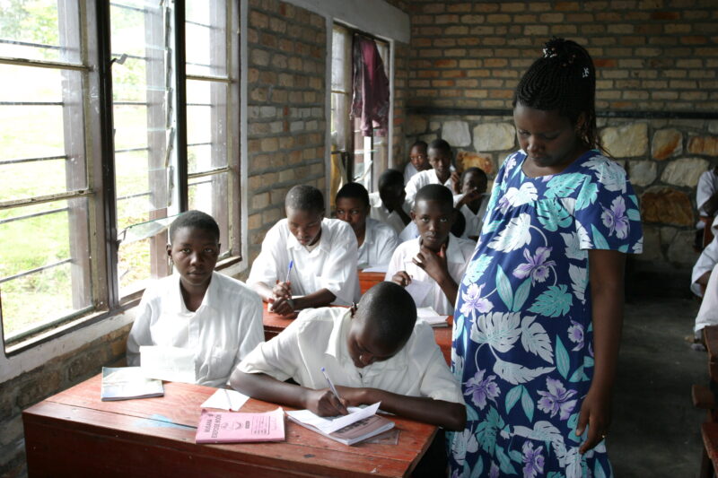 Teacher and Students in Rwanda — Students of refugees, returning to Rwanda after the genocide, attend schools built in a development program sponsored by ADR...