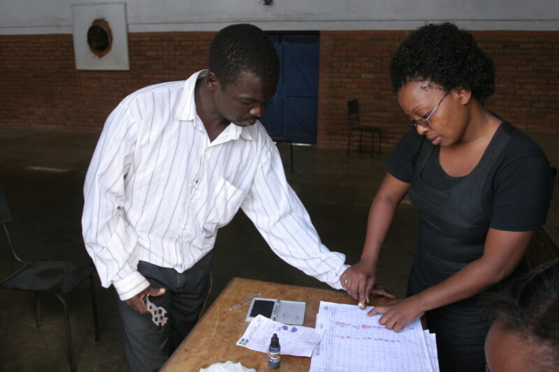 Emergency Food Distribution in Malawi — Man in Rural Malawi uses his finger print to receive his ration of maize during a drought — Emergency, Disaster, food...