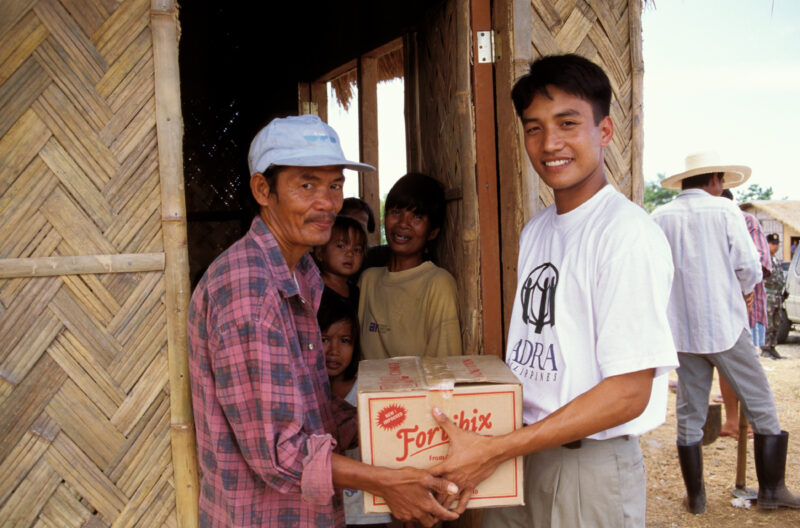 Food Aid in the Philippines — A displaced man receives an emergency food ration of Fortibix. — Emergency, Disaster, food security, distribution, Philippines