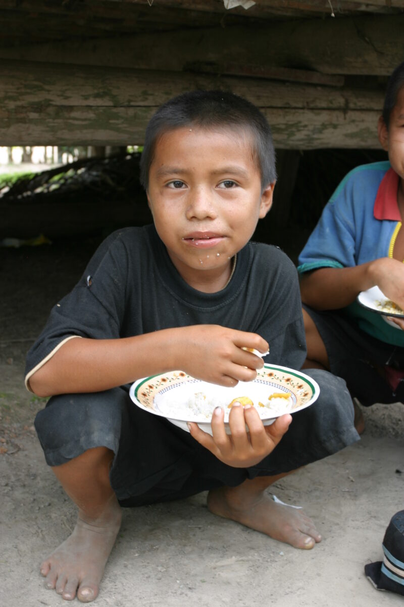 Eating Meal in Peru — Shipibo children eat food they have received from an ADRA distribution. — Peru, ADRA, Poverty, Development
