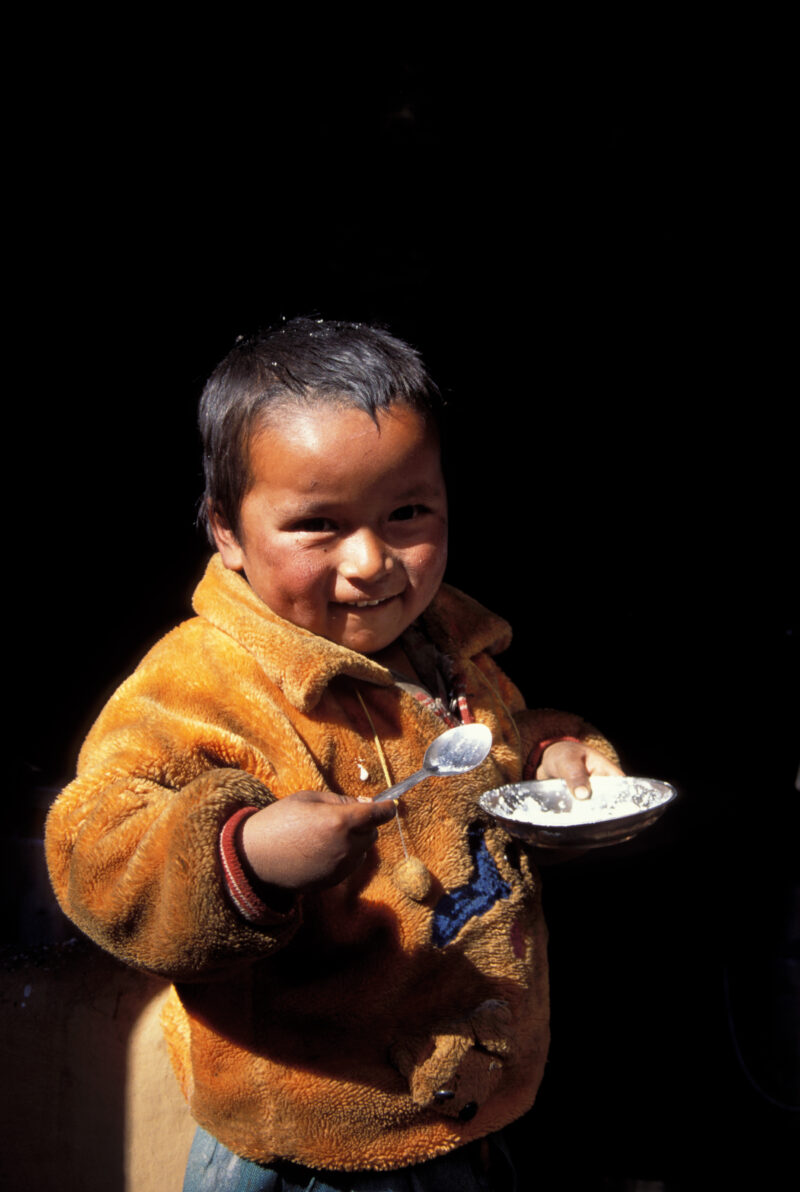 Eating in Nepal — Child in Nepal eats from bowl — Nepal, child, eating, boy, boys