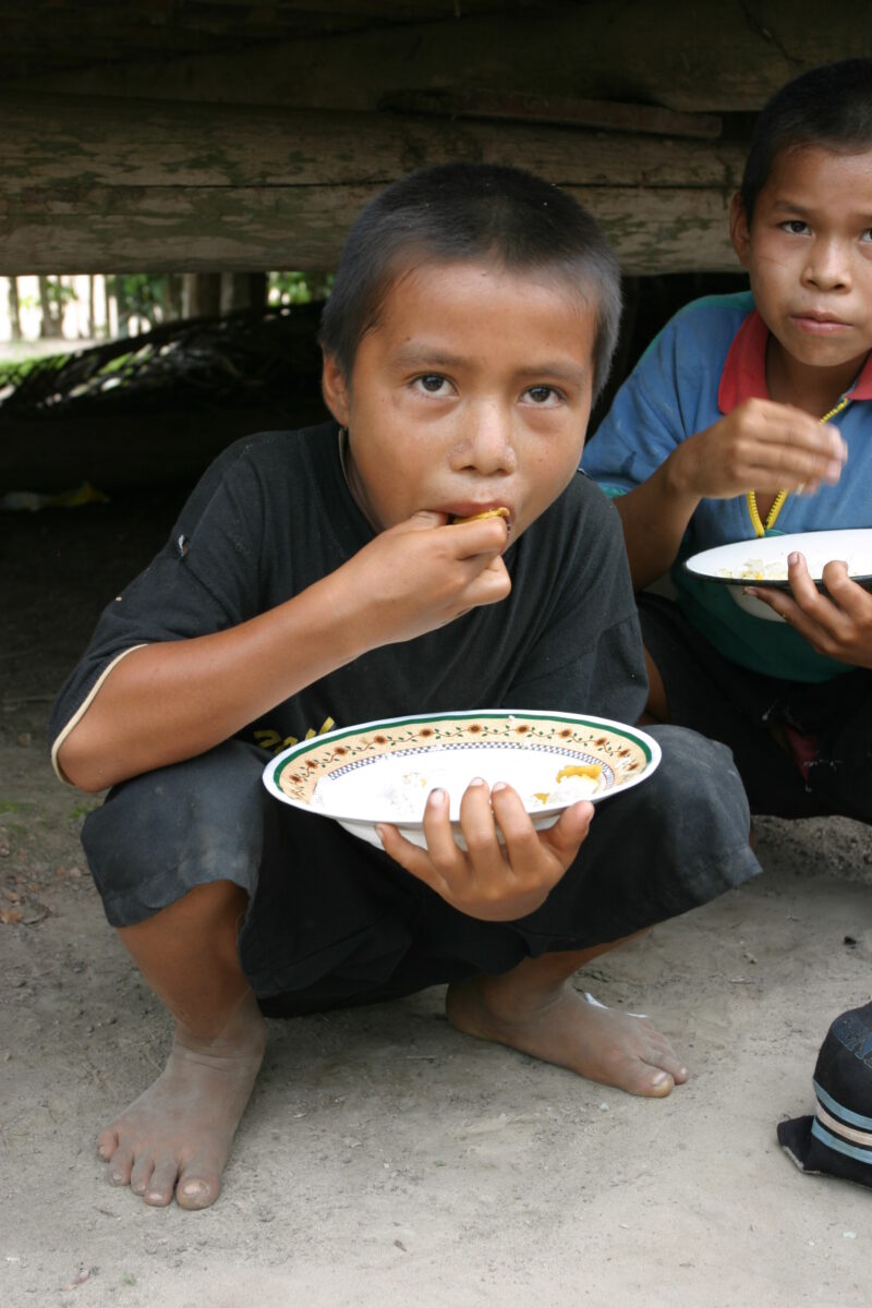 Eating Meal in Peru — Shipibo children eat food they have received from an ADRA distribution. — Peru, ADRA, Poverty, Development
