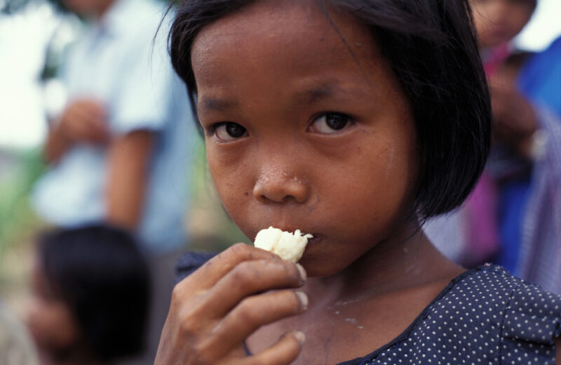 Eating in Cambodia — Poor children in Cambodia eat bananas they have just received in an emergency food distribuion. — Cambodia. children, child, eating, foo...