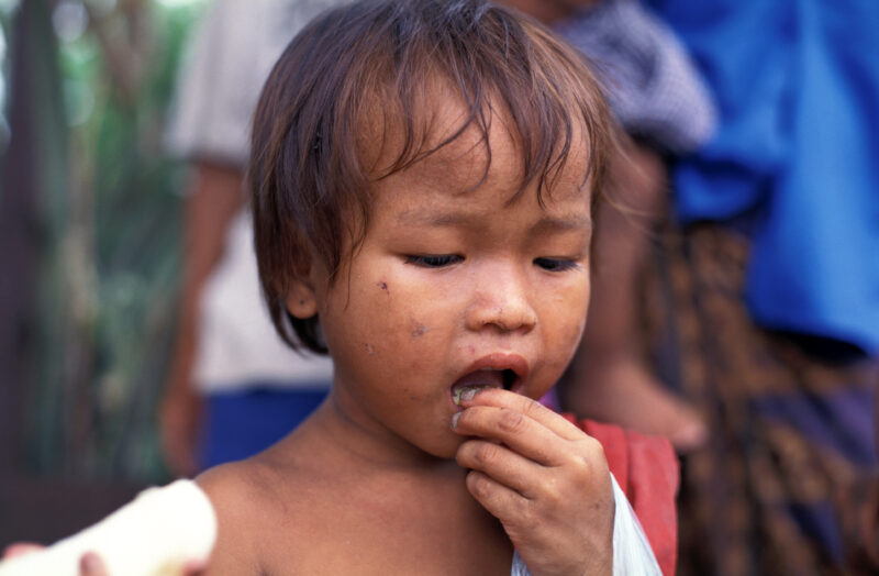 Eating in Cambodia — Poor children in Cambodia eat bananas they have just received in an emergency food distribuion. — Cambodia. children, child, eating, foo...