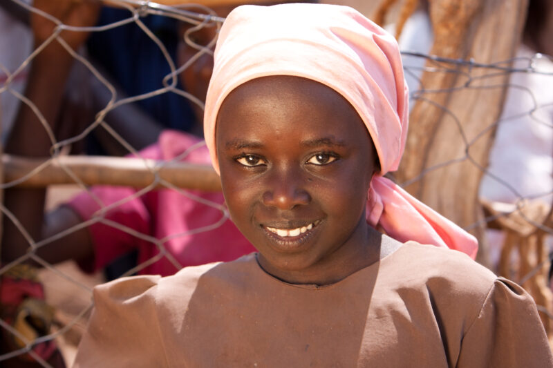 Girl inKenya — Girl smiles for camera in spite of her hunger from the drought that has hit her part of Kenya, Africa — Kenya, drought, girl, girls, faces