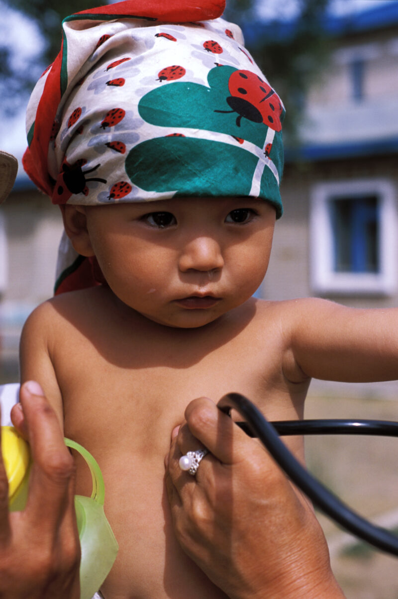 Doctor Checks Baby in Mongolia — Baby in orphanage gets checked by doctor working for ADRA — Mongolia, ADRA, Health, Doctor, Baby