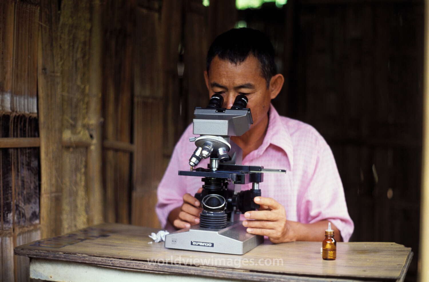 Man at Microscope in Thailand