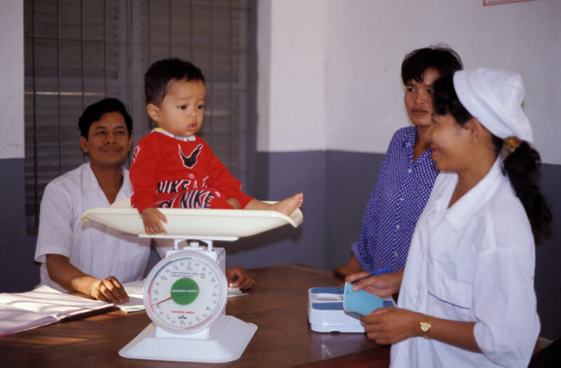 Growth Monitoring in Cambodia — Stock image of baby getting weighed at a remote ADRA health clinic in Cambodia — Cambodia, health clinic, baby, growth record...