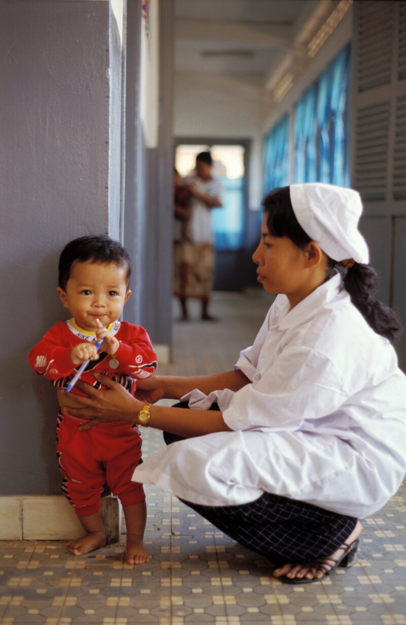 Growth Monitoring in Cambodia — Stock image of baby getting weighed at a remote ADRA health clinic in Cambodia — Cambodia, health clinic, baby, growth record...