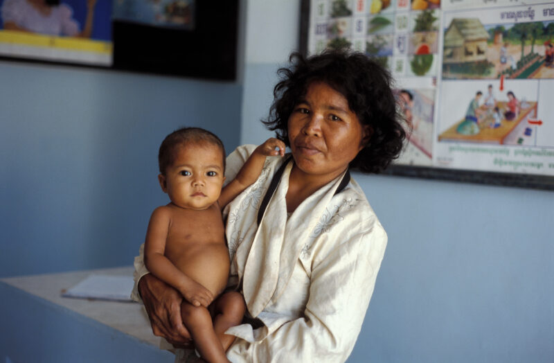 Mother Visits Clinic in Cambodia — Baby with worms visits clinic in Cambodia — Cambodia, SE Asia, Poverty, baby, mother