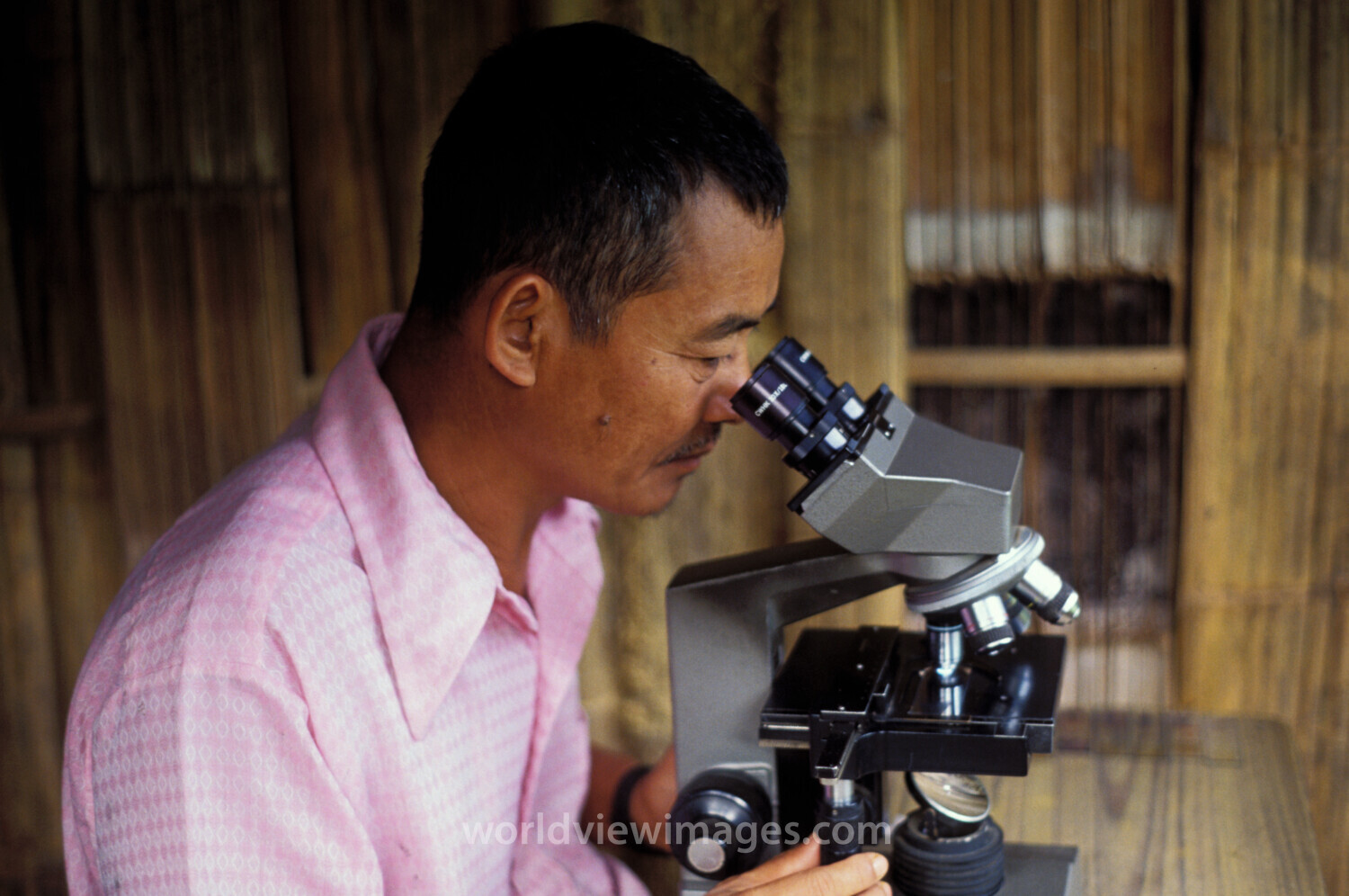 Man at Microscope in Thailand