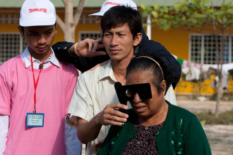 Eye Exam in Cambodia — Man gets a free Eye exam at a clinic in Cambodia supported by a volunteer group from the US — Cambodia, health, eye, eyes, exam