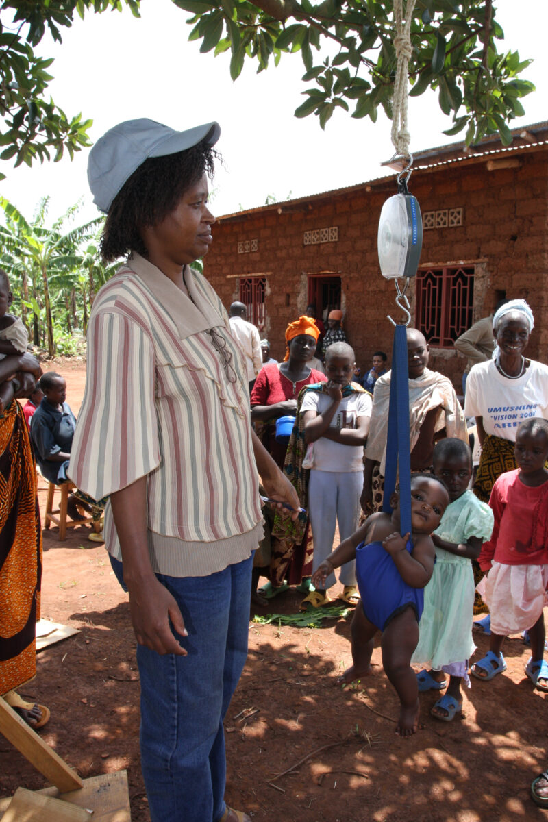 Weighing Baby in Rwanda — ADRA sets up a mobile clinic to check the health of villagers in remote rural Rwanda — Africa, Rwanda, health, clinic, village