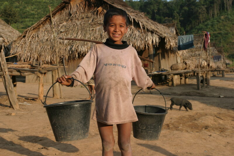 Boy with Water Buckets in Laos — Ethnic minority boy walks with water buckets to the new water tap installed by ADRA in his remote village in Laos — Laos, AD...