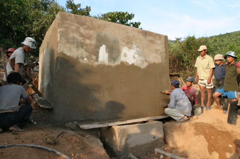 Water Tank in Laos — Men work on building a water storage tank for their new gravity fed water system in an ethnic minority village in Laos — Laos, ADRA, ADR...
