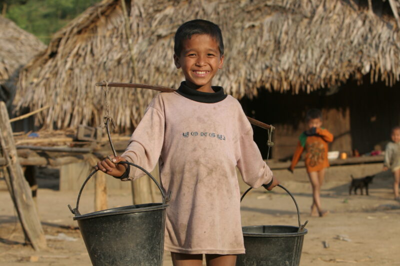 Boy with Water Buckets in Laos — Ethnic minority boy walks with water buckets to the new water tap installed by ADRA in his remote village in Laos — Laos, AD...