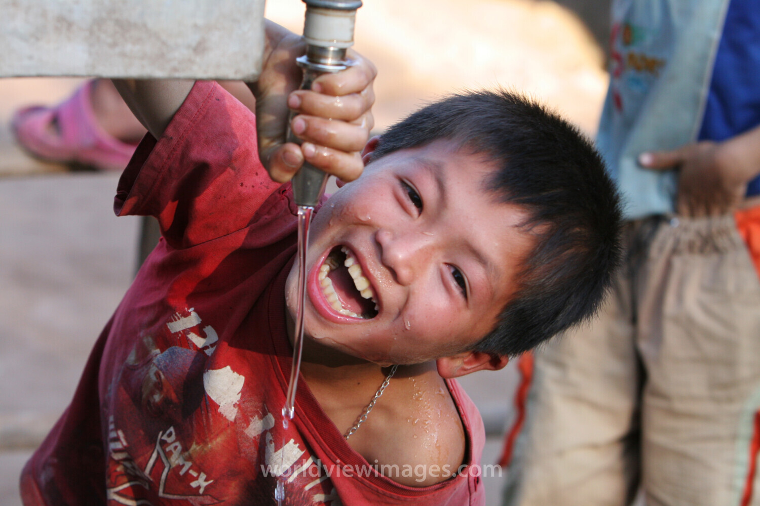 Boy gets water in Laos