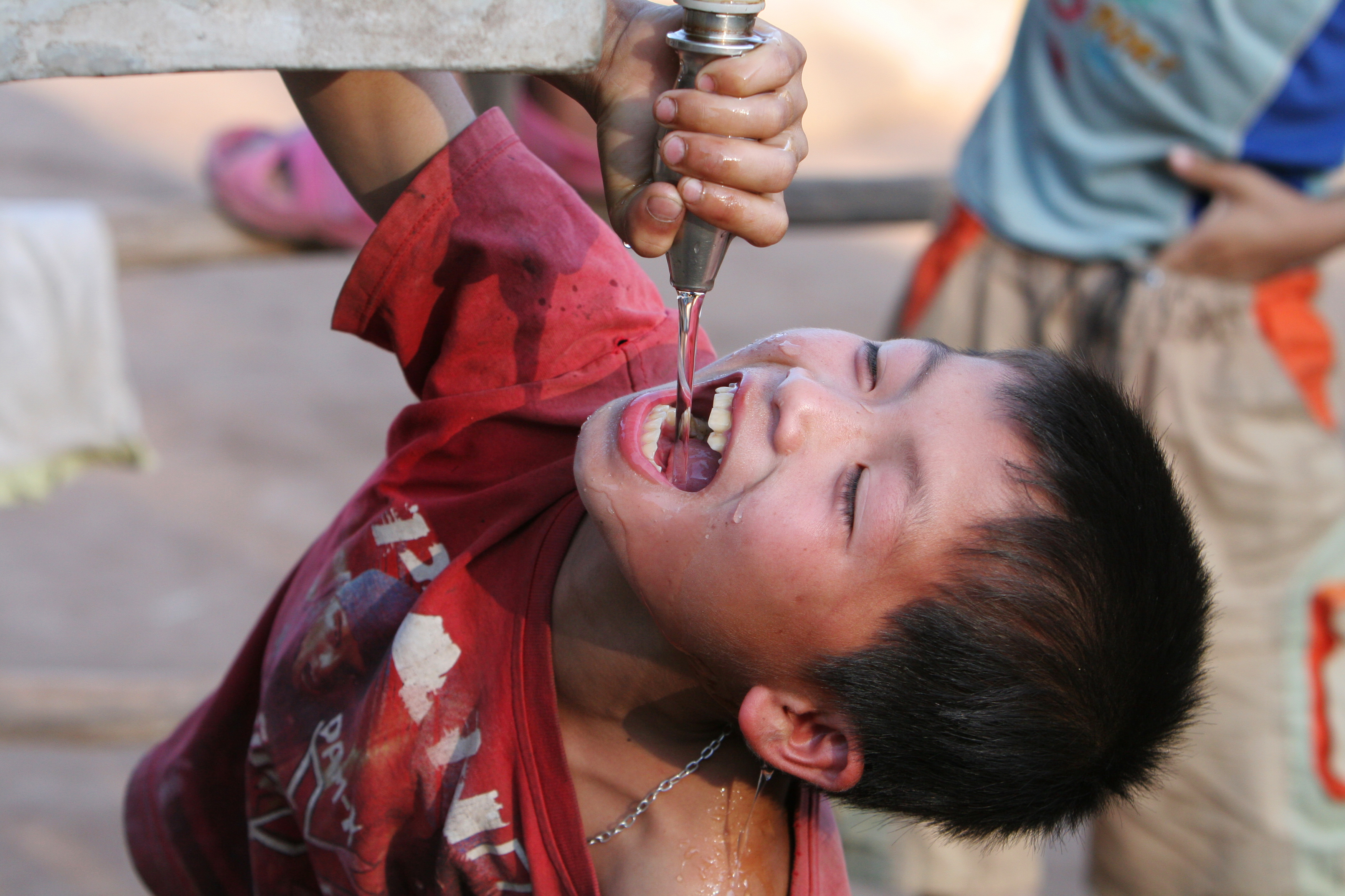 Boy gets water in Laos