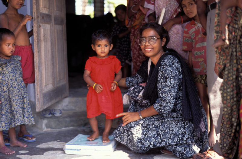 Growth Monitoring in Bangladesh — Stock Image of child getting weighed at an ADRA Clinic in Bangladesh, for growth monitoring. — Bangladesh, health, children...