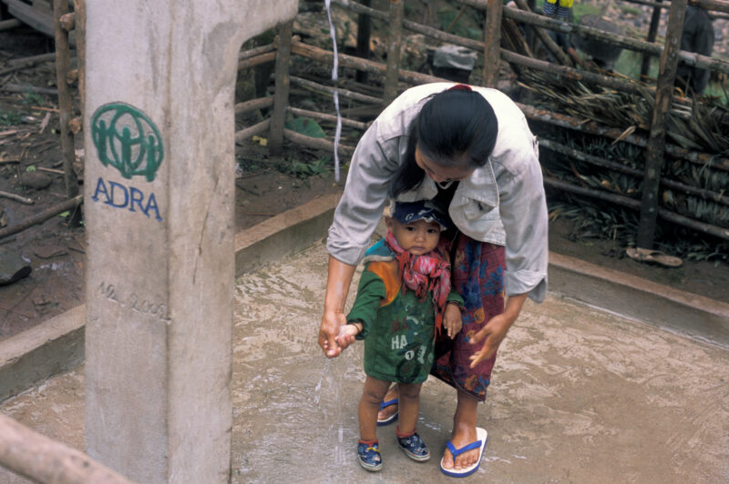 New Water System in Laos — Stock Image of villagers ina rural village in Laos, happy with their new gravity fed water system, installed with the help of ADRA...