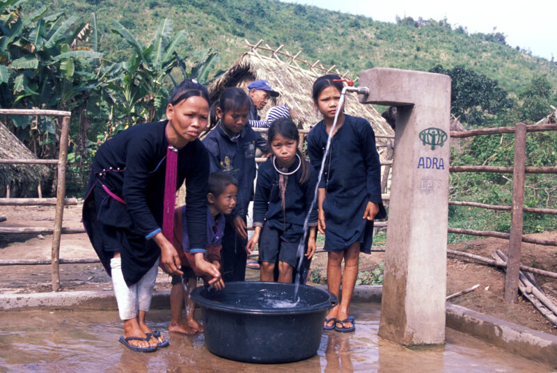 New Water System in Laos — Stock Image of villagers ina rural village in Laos, happy with their new gravity fed water system, installed with the help of ADRA...