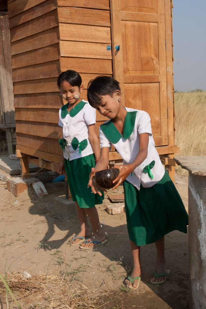 Toilets at School in Burma — Children run to use the new facilities, at their school, provided by a program on health and sanitation presented in their villa...