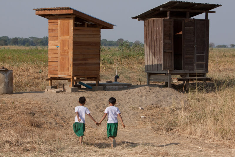 Toilets at School in Burma — Children run to use the new facilities, at their school, provided by a program on health and sanitation presented in their villa...