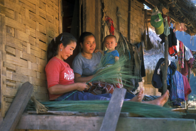 Making Brooms in Laos — Woman works on the front veranda of her bamboo home in Laos, making brooms for income. — Laos, Poverty, woman, broom making, Income