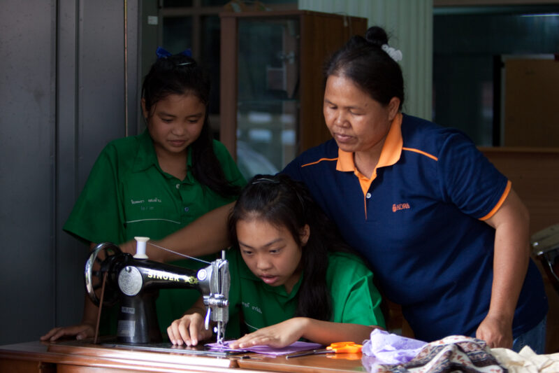 Learning to Sew in thailand — Stock image of an ethnic minority girl in Thailand learning to sew — Thailand, gilr, girls, skills training, learning to sew