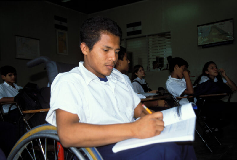 Disabled boy in Honduras — Boy in wheelcahir takes notes in class — Honduras, boy, student, Disability
